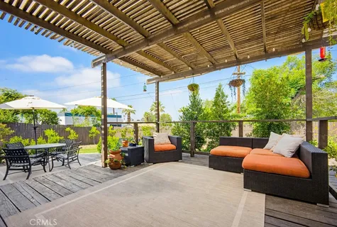 a balcony with furniture and a view of city