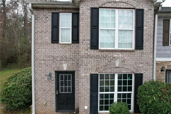 a brick house with a large windows
