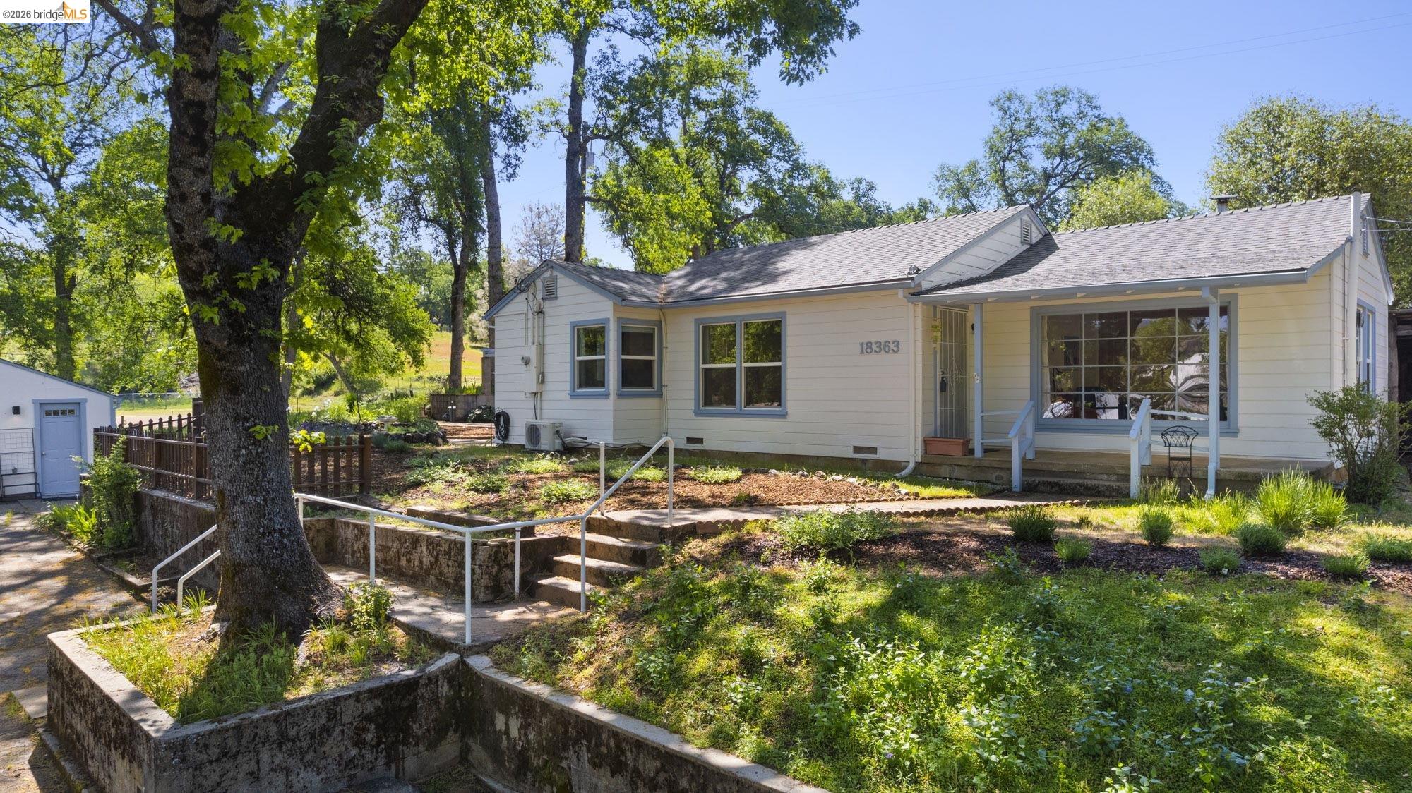 18363 Yosemite Road Tuolumne, CA 95379 - Photo 28 of 34 Ranch-style exterior with light-colored siding, a covered porch, and a gray shingle roof