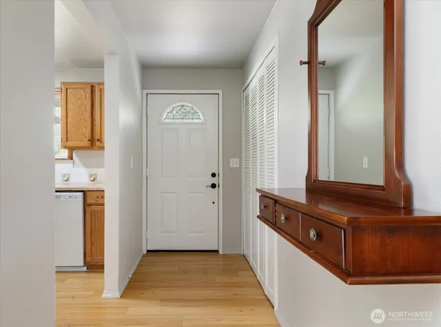 a view of a hallway with wooden floor and staircase