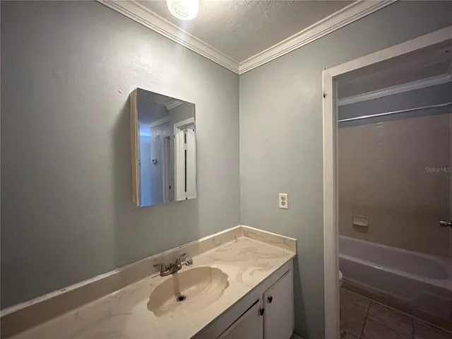 a bathroom with a granite countertop sink toilet and mirror