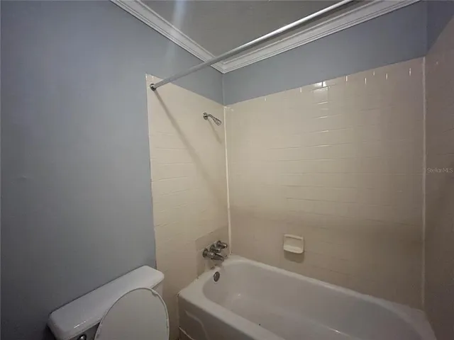 a bathroom with a bathtub and a toilet