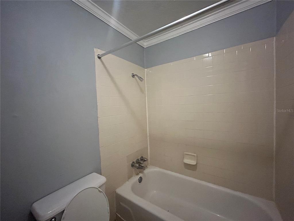 2811 Southwest Archer Road, Unit M106 Gainesville, FL 32608 - Photo 13 of 26 a bathroom with a bathtub and a toilet