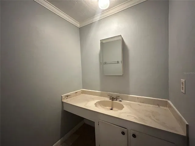 a bathroom with a sink and a mirror