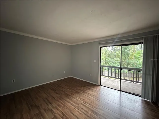 a view of a room with wooden floor and walls