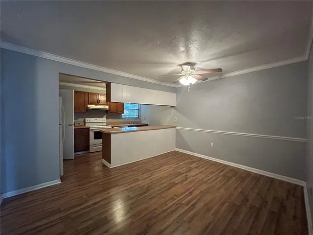 a view of kitchen with sink and wooden floor