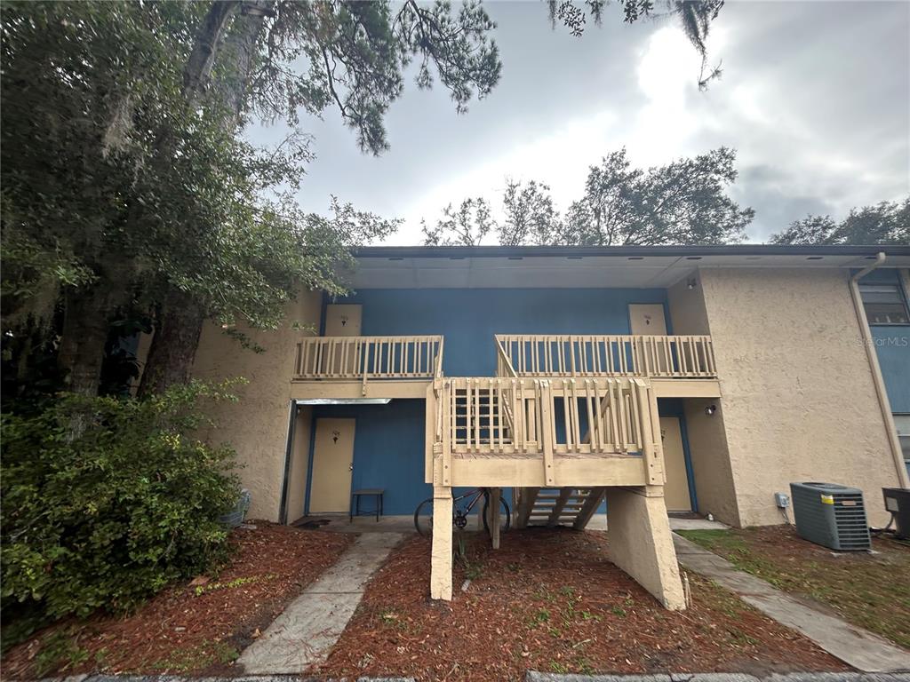 2811 Southwest Archer Road, Unit M106 Gainesville, FL 32608 - Photo 21 of 26 a view of a house with large windows and a table and chair