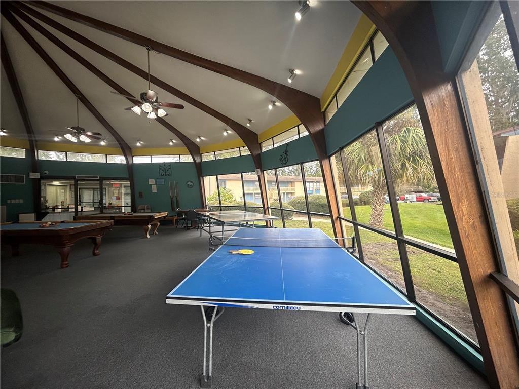 2811 Southwest Archer Road, Unit M106 Gainesville, FL 32608 - Photo 25 of 26 a room with wooden floor pool table and chairs