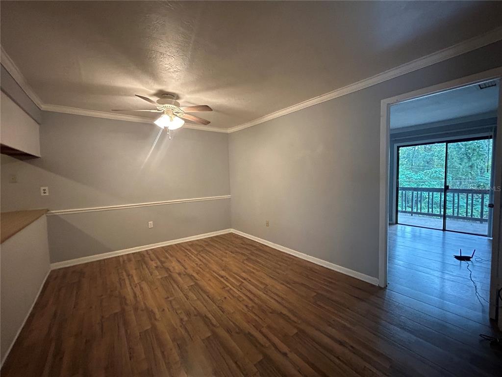 2811 Southwest Archer Road, Unit M106 Gainesville, FL 32608 - Photo 3 of 26 wooden floor in an empty room with a window