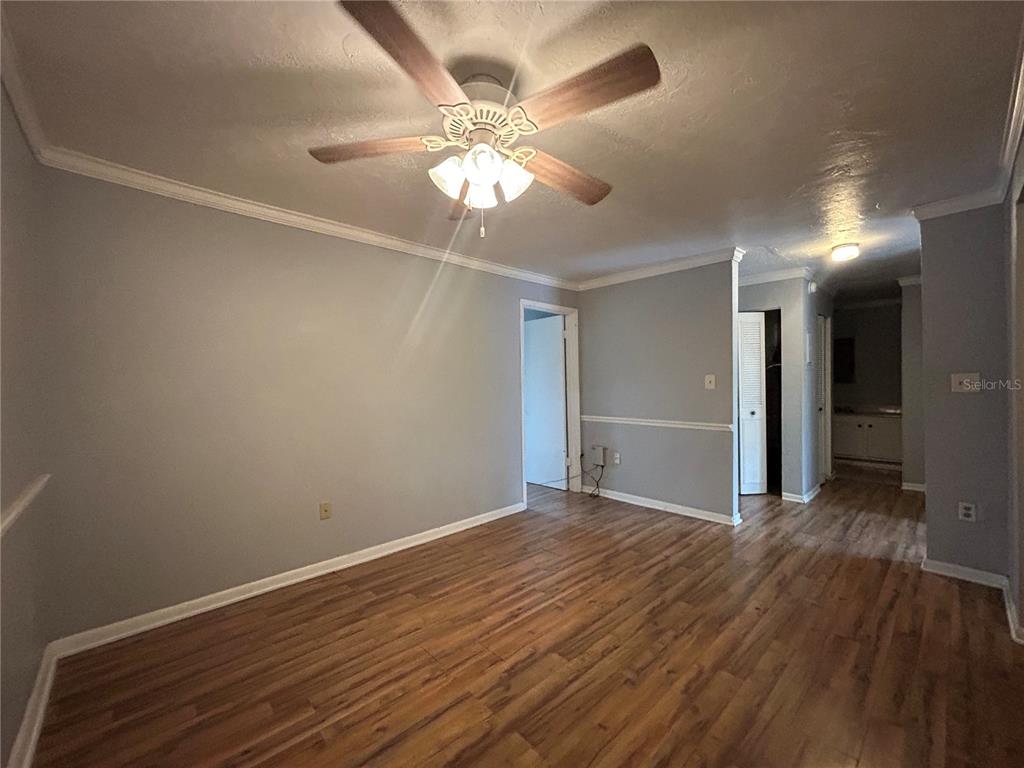 2811 Southwest Archer Road, Unit M106 Gainesville, FL 32608 - Photo 4 of 26 a view of an empty room with wooden floor