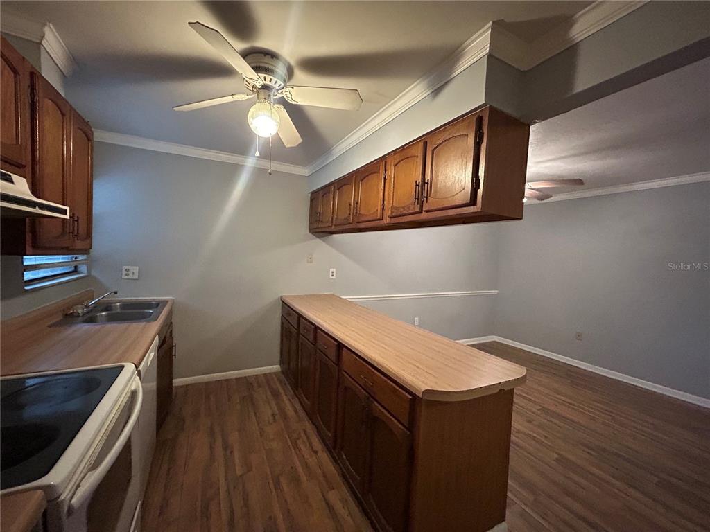 2811 Southwest Archer Road, Unit M106 Gainesville, FL 32608 - Photo 5 of 26 a kitchen with a stove and a microwave