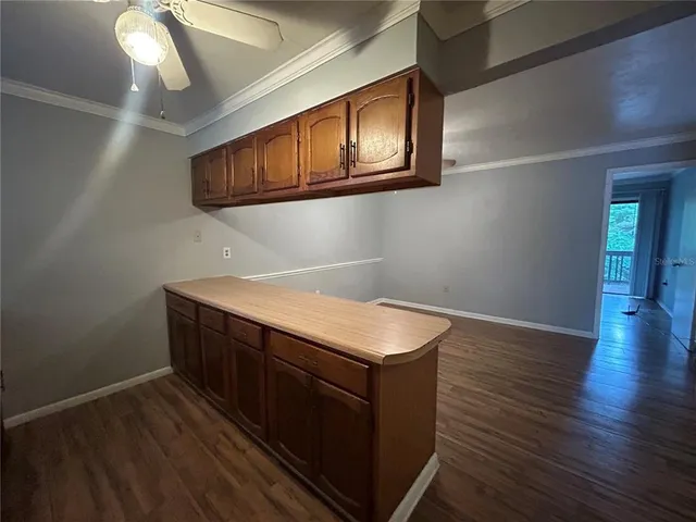 a kitchen with kitchen island a wooden floor