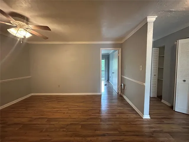 a view of a room with wooden floor