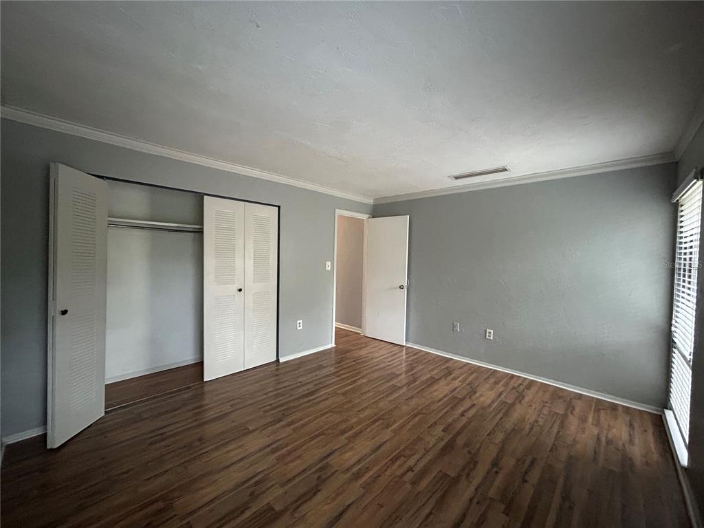 2811 Southwest Archer Road, Unit M106 Gainesville, FL 32608 - Photo 10 of 26 a view of an empty room with wooden floor