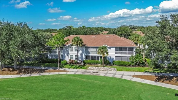 a aerial view of a house with a yard and a fountain