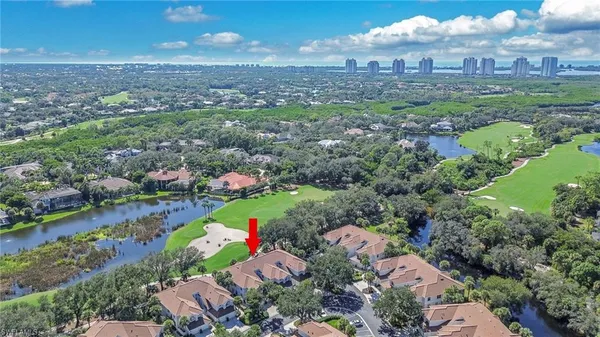 an aerial view of residential houses with outdoor space and lake view