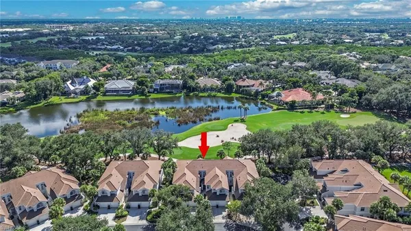 an aerial view of residential houses with outdoor space and river