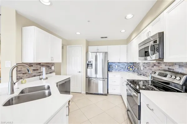 a kitchen with a sink stove and refrigerator