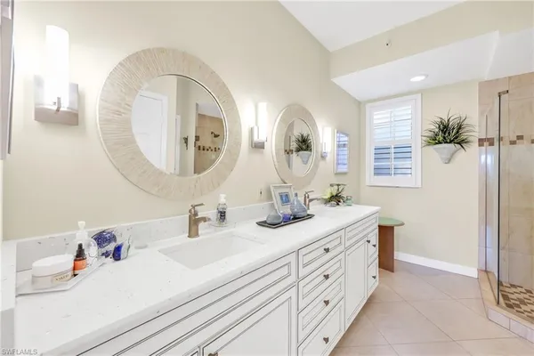 a bathroom with a double vanity sink and a mirror