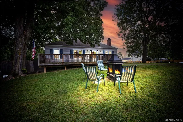 a view of a house with backyard and sitting area