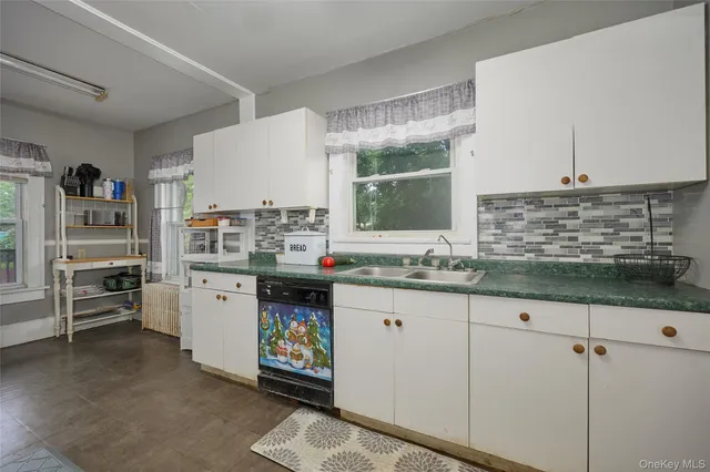 a kitchen with stainless steel appliances kitchen island granite countertop a sink and cabinets
