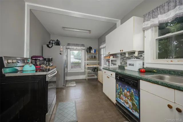 a kitchen that has a lot of cabinets a sink and a stove