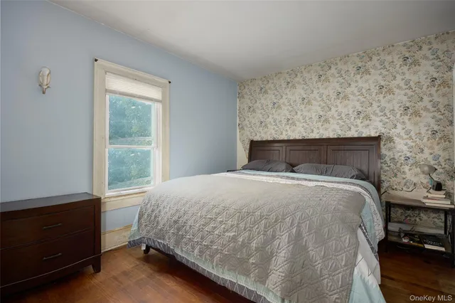a bedroom with a bed and window