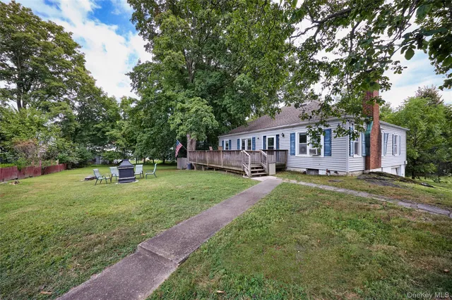 a view of a house with a yard and sitting area