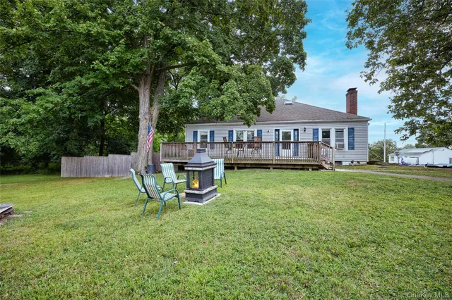 a view of a house with a yard patio and sitting area