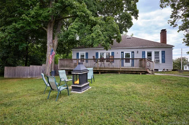 a view of a house with backyard porch and sitting area