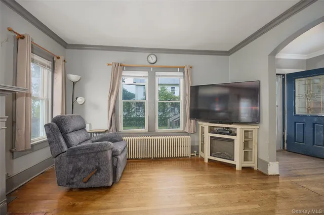 a living room with furniture and a flat screen tv