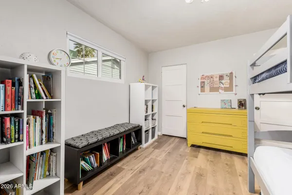 a living room with furniture and a book shelf