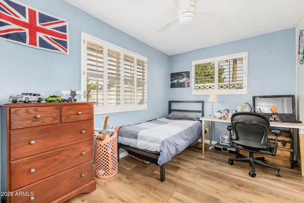 a bedroom with a bed and a desk