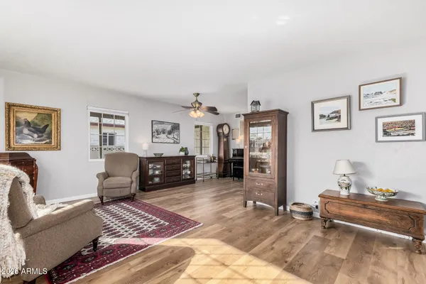 a living room with furniture and wooden floor