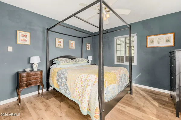 a spacious bedroom with a bed and a dresser