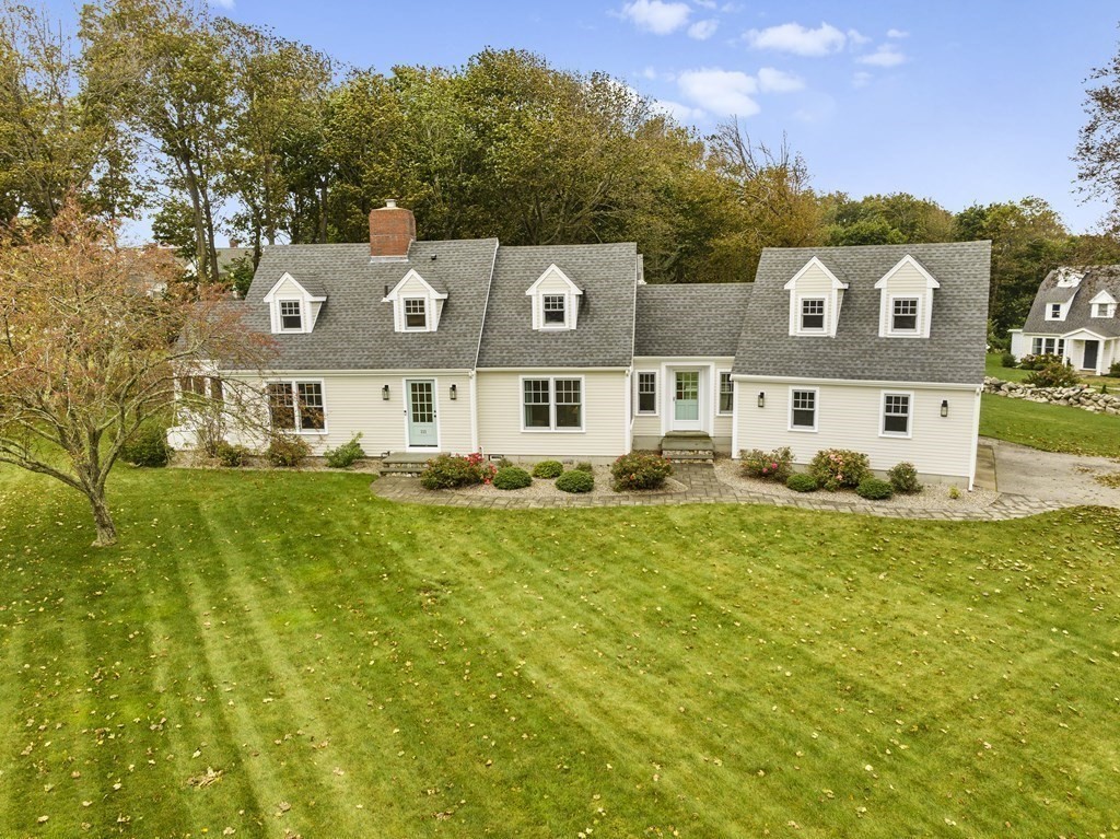 111 Mann Hill Road Scituate, MA 02066 - Photo 2 of 37 a view of a big house with a large yard next to a road
