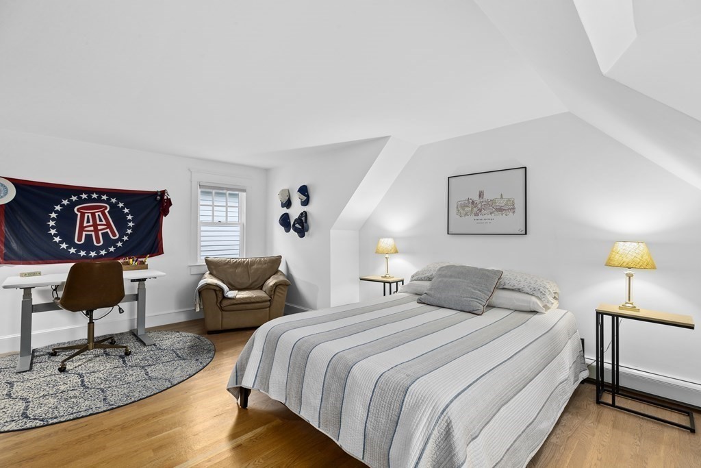 111 Mann Hill Road Scituate, MA 02066 - Photo 23 of 37 a bedroom with a bed a couch and a lamp on table