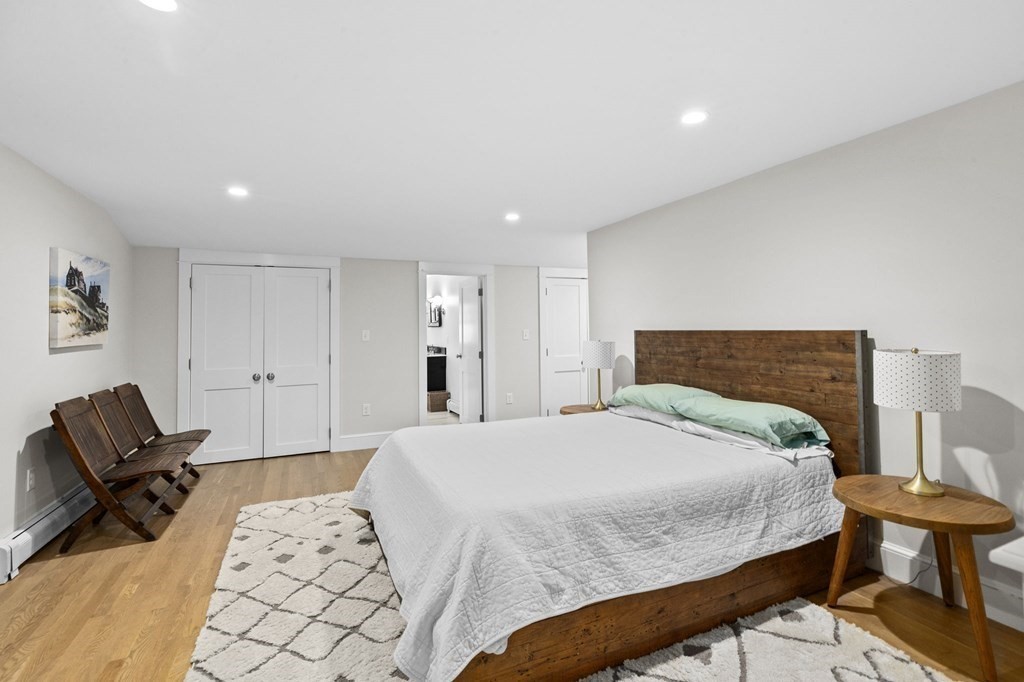 111 Mann Hill Road Scituate, MA 02066 - Photo 27 of 37 a spacious bedroom with a bed and chair