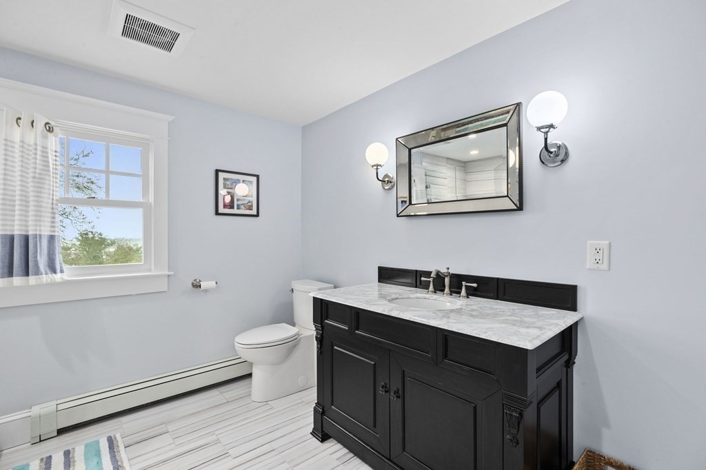 111 Mann Hill Road Scituate, MA 02066 - Photo 30 of 37 a bathroom with a sink a toilet and a window