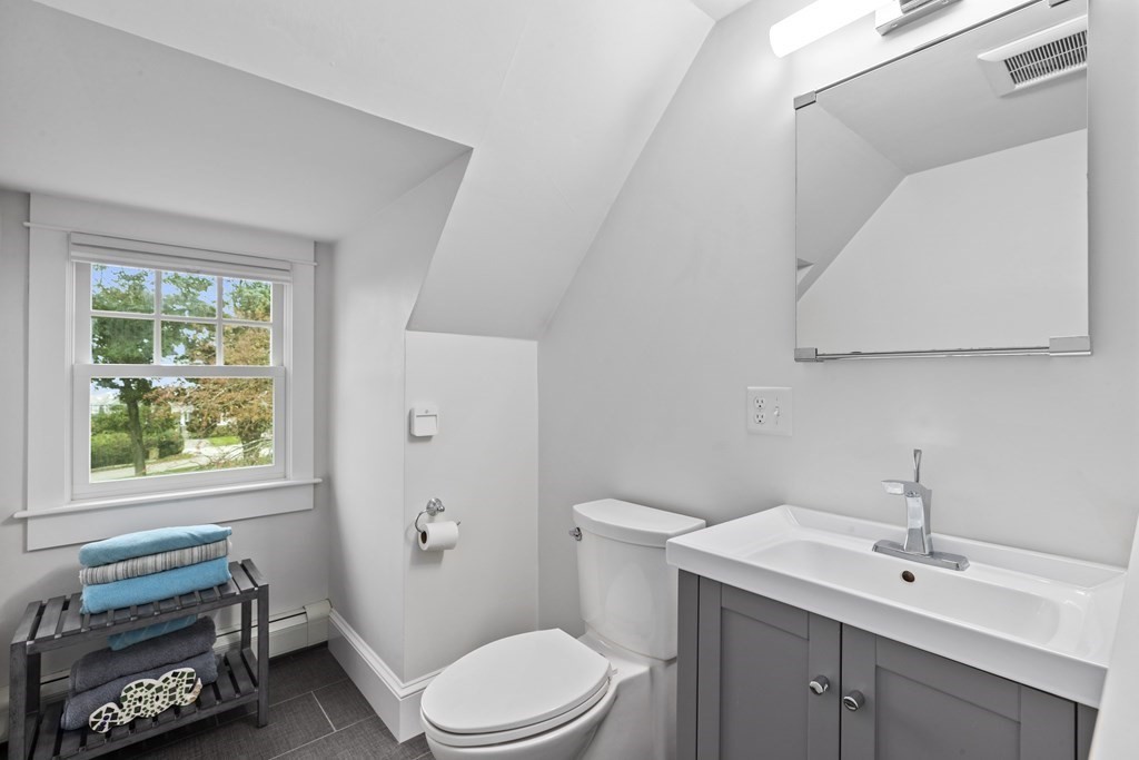 111 Mann Hill Road Scituate, MA 02066 - Photo 31 of 37 a bathroom with a sink a toilet and vanity