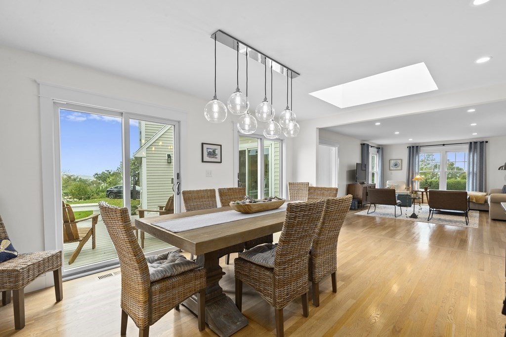 111 Mann Hill Road Scituate, MA 02066 - Photo 10 of 37 a view of a dining room with furniture wooden floor and chandelier