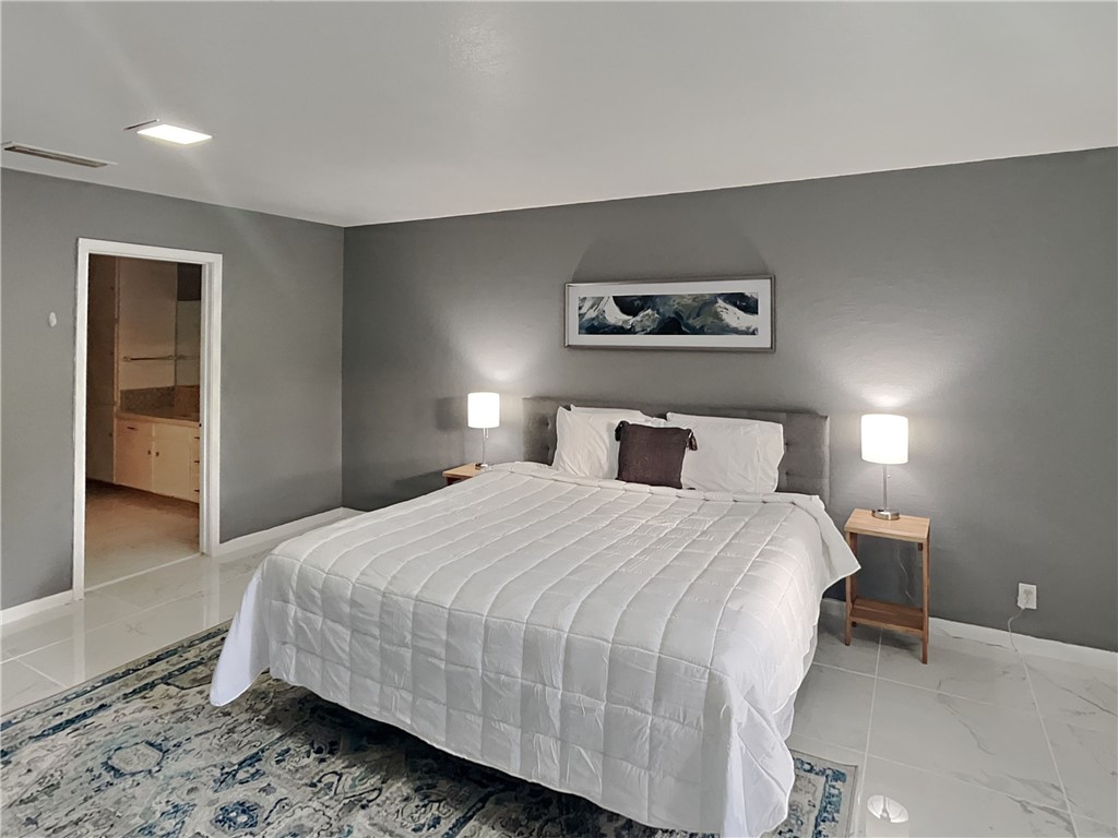 3554 Denver Avenue Corpus Christi, TX 78411 - Photo 11 of 21 a bedroom with a bed and a painting on the wall