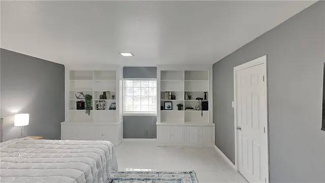 a large white bedroom with kitchen