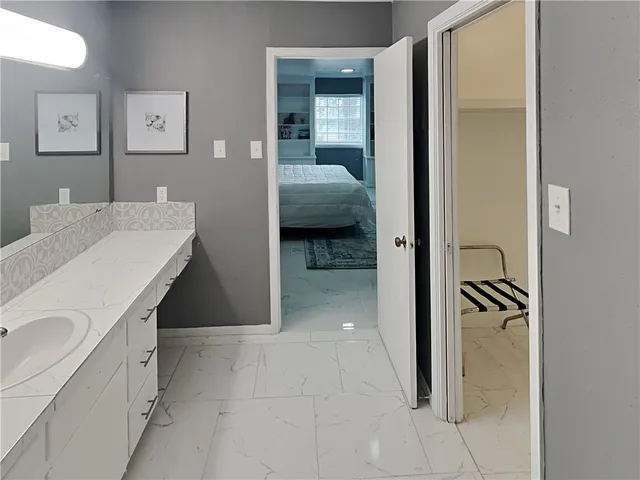 a en suite bathroom with a sink and a mirror