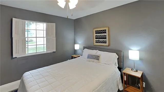 a bedroom with a bed and a window