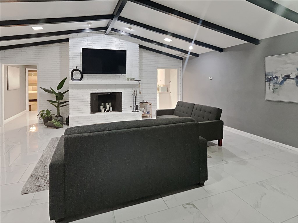 3554 Denver Avenue Corpus Christi, TX 78411 - Photo 3 of 21 a living room with furniture and a fireplace