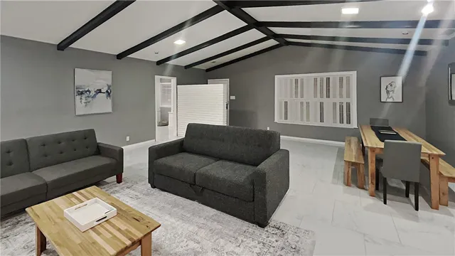 a living room with furniture and a piano