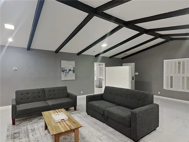 a living room with furniture and a rug