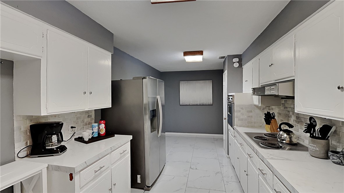 3554 Denver Avenue Corpus Christi, TX 78411 - Photo 10 of 21 a kitchen with stainless steel appliances a sink stove refrigerator and cabinets