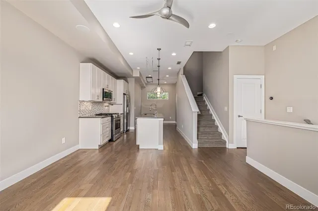 a bathroom with a granite countertop sink a toilet and shower
